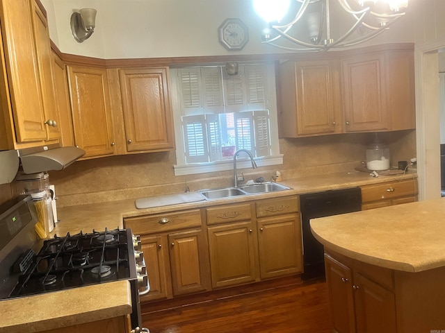 kitchen featuring sink, dark wood-type flooring, an inviting chandelier, pendant lighting, and black appliances