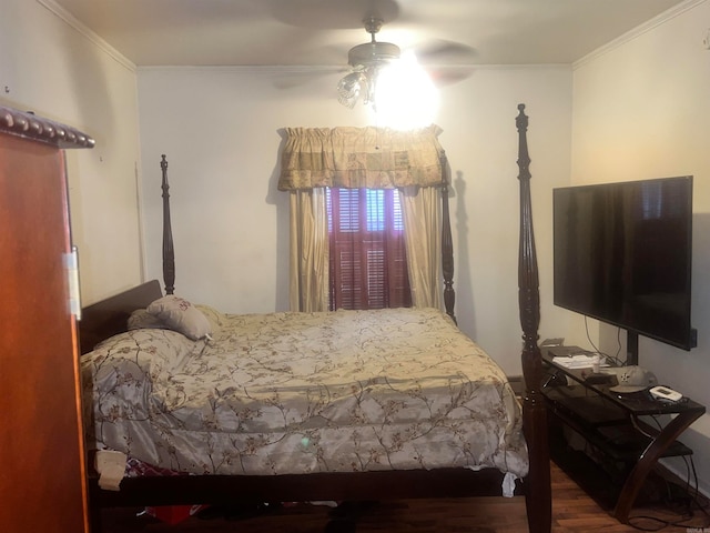 bedroom featuring hardwood / wood-style floors, ceiling fan, and crown molding