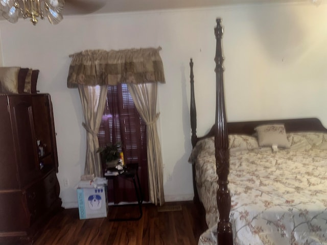 bedroom with dark hardwood / wood-style flooring and ceiling fan