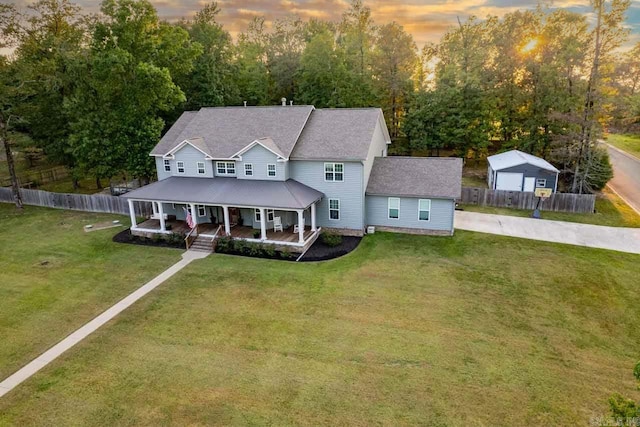 view of front facade featuring a lawn and covered porch