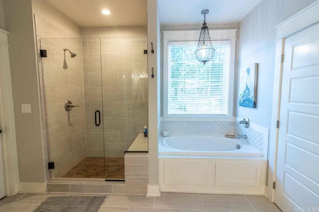 bathroom featuring shower with separate bathtub