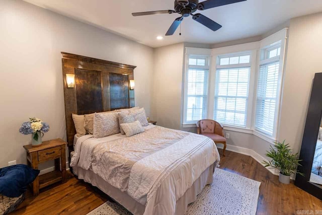 bedroom with multiple windows, ceiling fan, and hardwood / wood-style floors