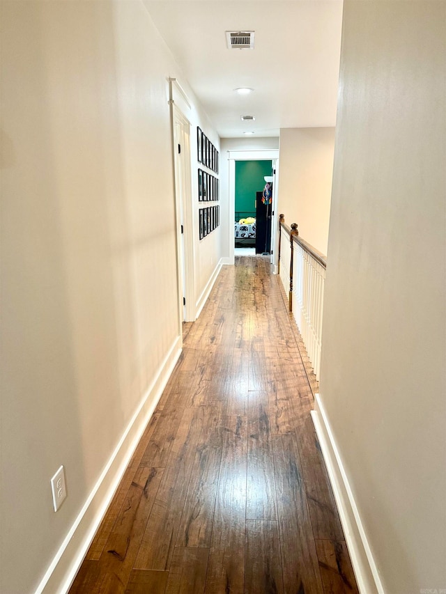 corridor with wood-type flooring