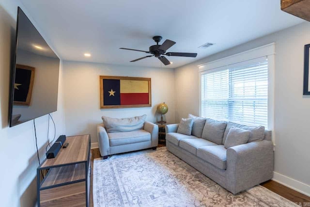 living room featuring wood-type flooring and ceiling fan