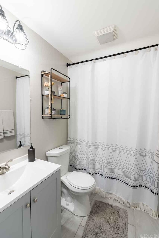 bathroom with tile patterned floors, vanity, and toilet