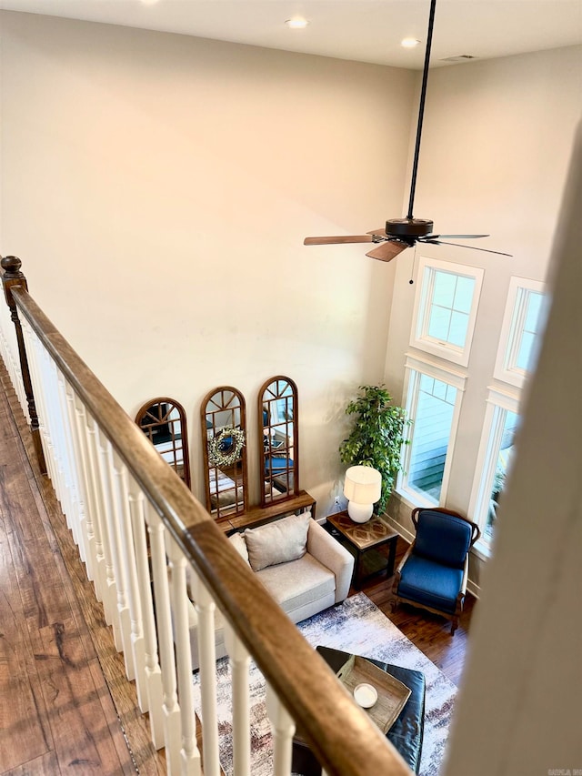 living room featuring a towering ceiling and dark hardwood / wood-style floors