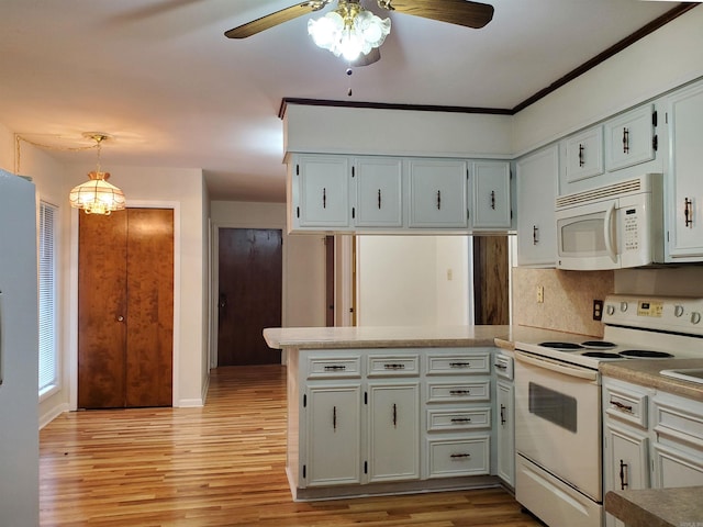 kitchen featuring white cabinetry, kitchen peninsula, light hardwood / wood-style floors, decorative light fixtures, and white appliances