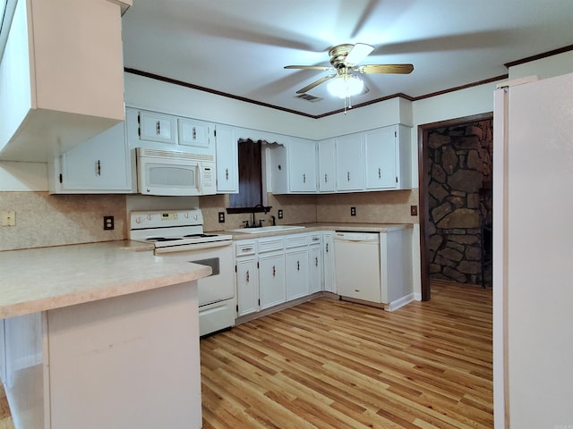 kitchen featuring white cabinetry, sink, kitchen peninsula, white appliances, and light wood-type flooring