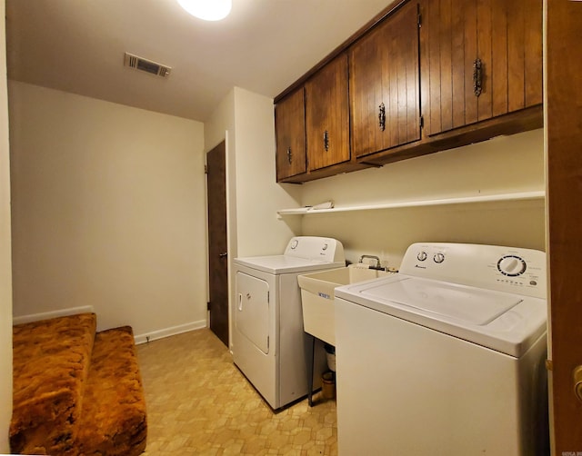 laundry room with sink, cabinets, and independent washer and dryer