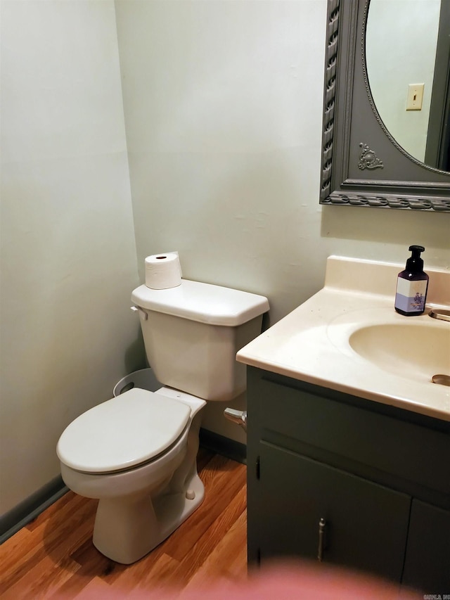 bathroom with vanity, hardwood / wood-style floors, and toilet