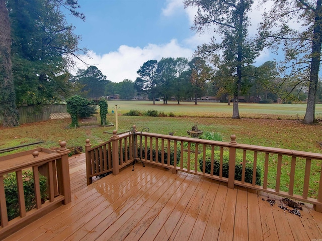 wooden deck featuring a yard