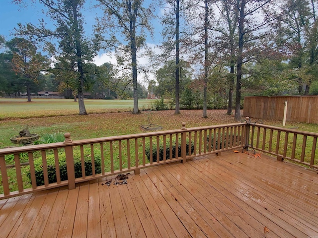 wooden deck with a lawn