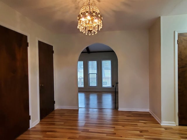 interior space with a chandelier and wood-type flooring