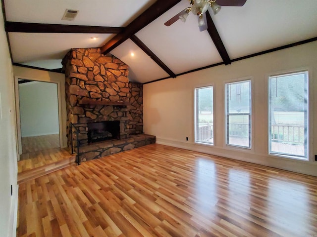 unfurnished living room featuring light hardwood / wood-style flooring and lofted ceiling with beams