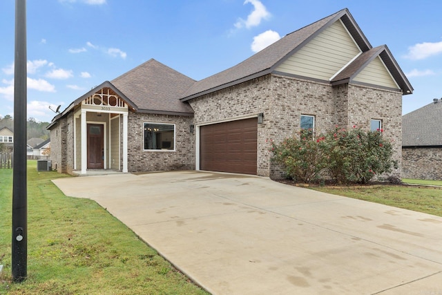 view of front of home with a front yard, a garage, and central AC unit