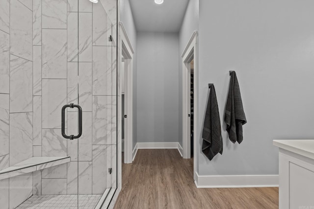 bathroom featuring wood-type flooring and walk in shower