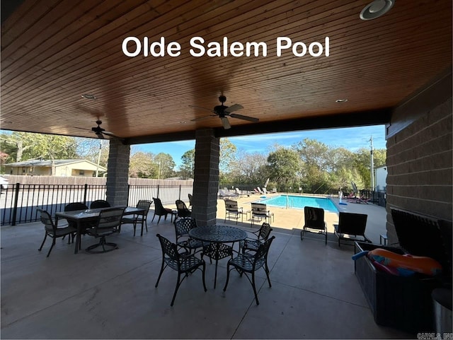 view of patio featuring a fenced in pool and ceiling fan