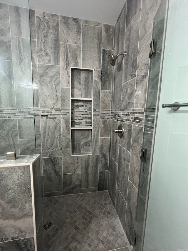 bathroom featuring a shower with shower door