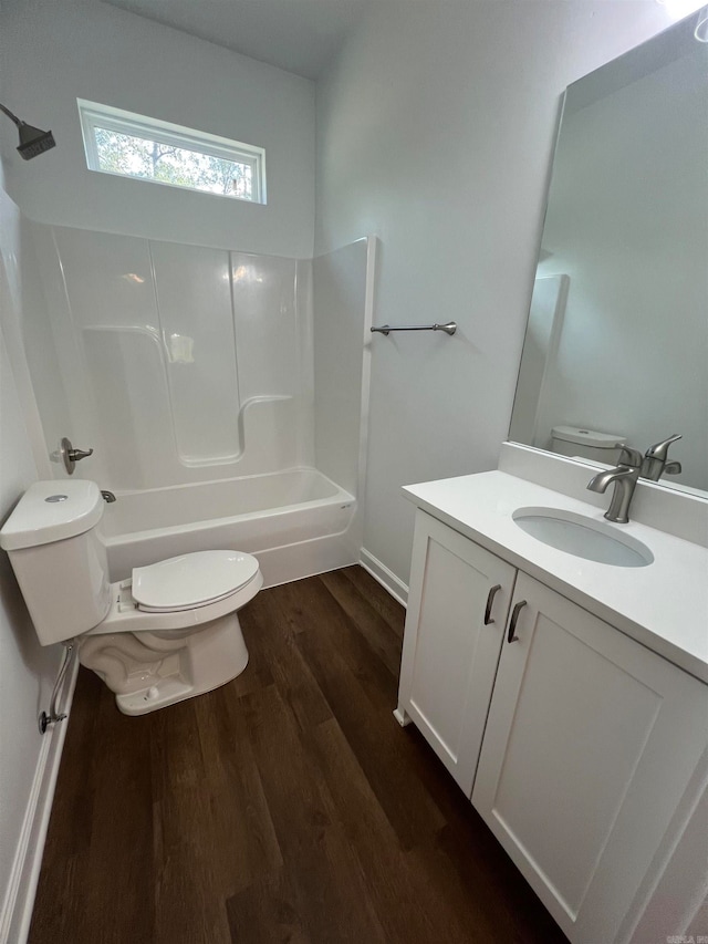 full bathroom with hardwood / wood-style floors, vanity,  shower combination, and toilet