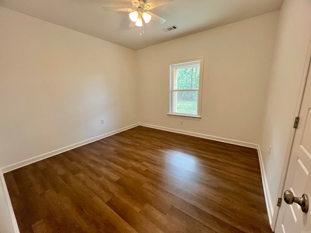 unfurnished room with ceiling fan and dark hardwood / wood-style flooring