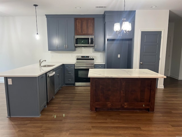 kitchen with decorative light fixtures, sink, dark hardwood / wood-style floors, and stainless steel appliances