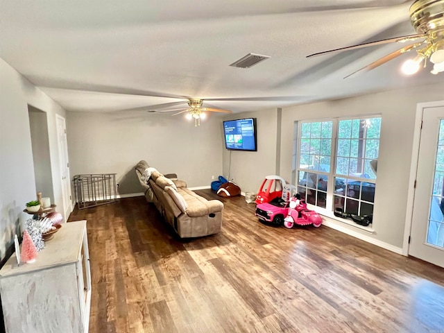 playroom with ceiling fan and wood-type flooring