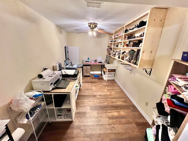 office space with ceiling fan and wood-type flooring