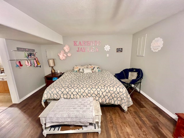 bedroom with dark hardwood / wood-style flooring