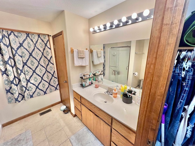 bathroom with tile patterned flooring, a shower, vanity, and toilet