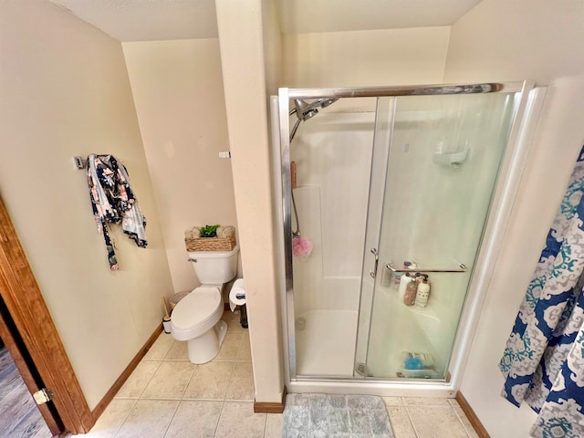 bathroom with toilet, tile patterned floors, and an enclosed shower