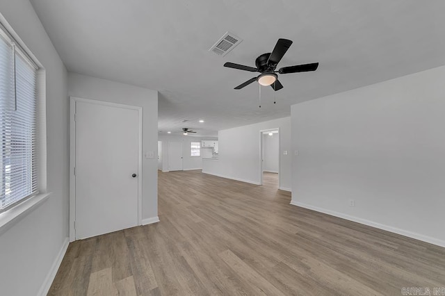 unfurnished living room with light hardwood / wood-style flooring and ceiling fan