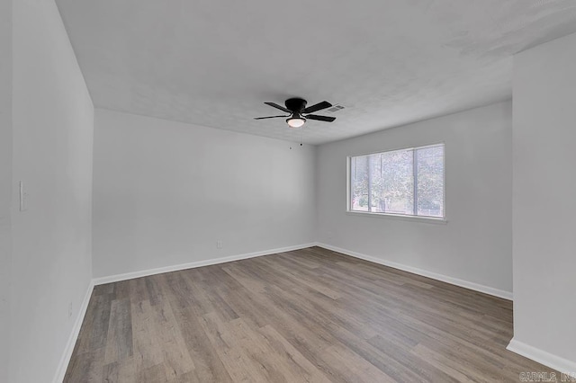 unfurnished room with ceiling fan and light wood-type flooring