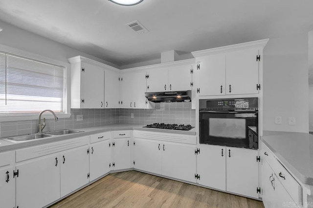 kitchen with white cabinetry, sink, oven, and gas cooktop