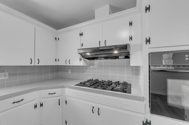 kitchen featuring white cabinets, tasteful backsplash, and black appliances