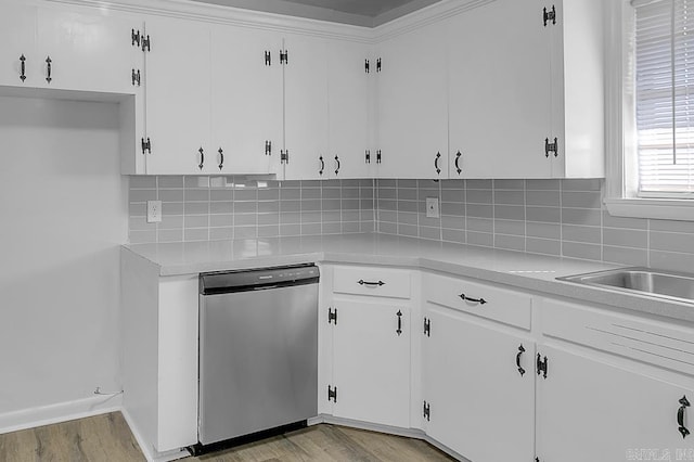 kitchen with white cabinets, stainless steel dishwasher, and light wood-type flooring