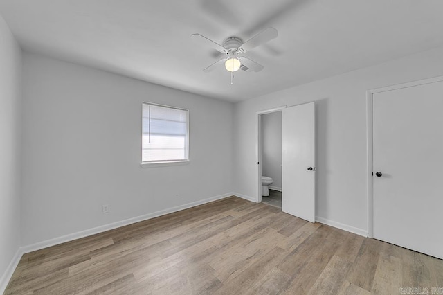 unfurnished bedroom with light hardwood / wood-style floors, ceiling fan, and ensuite bathroom