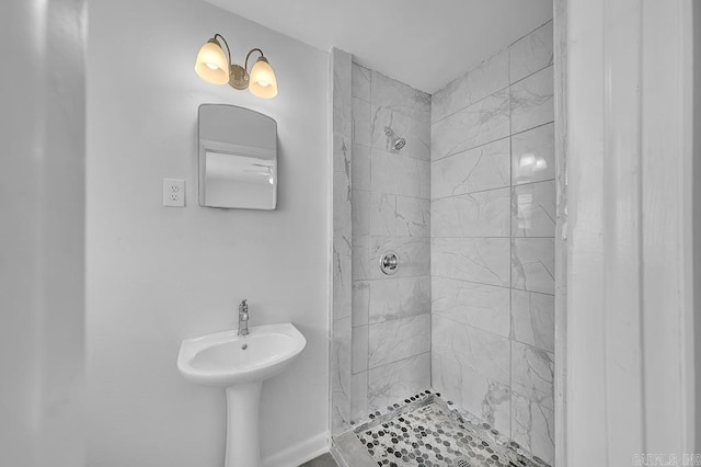 bathroom with a tile shower