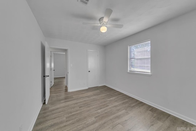 unfurnished bedroom with a closet, light hardwood / wood-style floors, and ceiling fan