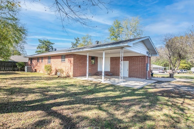 view of front of property with central air condition unit, a front lawn, and a patio