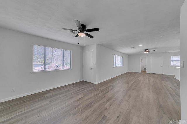 unfurnished living room featuring ceiling fan and light hardwood / wood-style floors