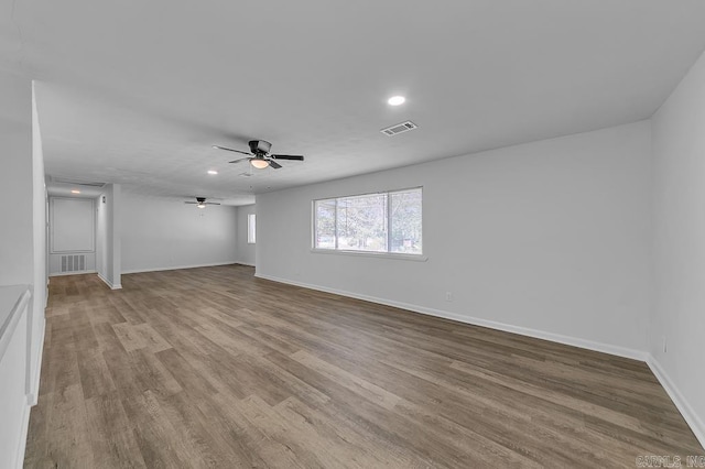 unfurnished living room with ceiling fan and light hardwood / wood-style floors