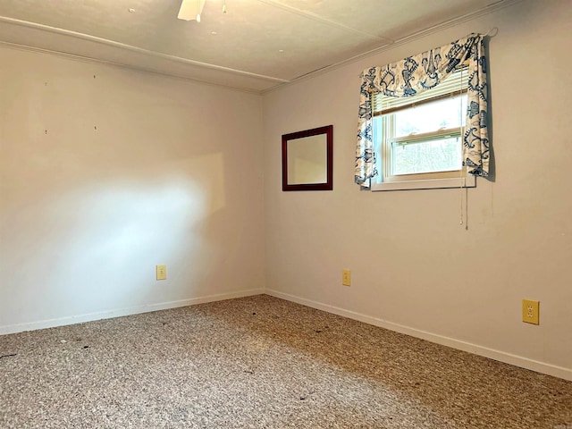 empty room featuring carpet flooring and crown molding