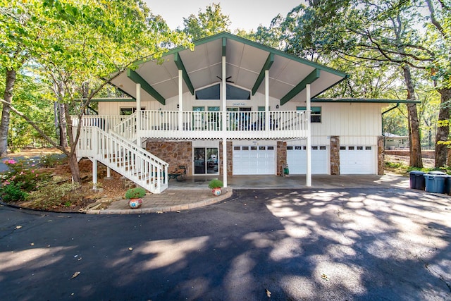 view of front of property with ceiling fan, a porch, and a garage