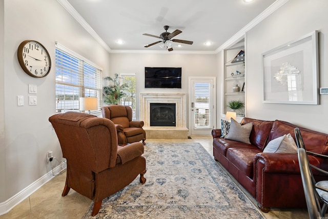 living room with ceiling fan, crown molding, light tile patterned floors, built in features, and a fireplace