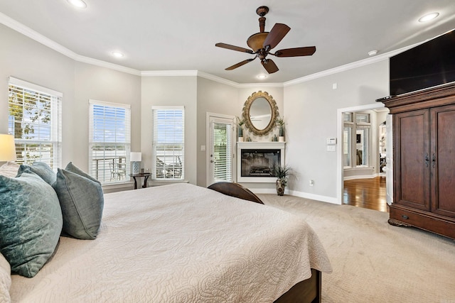 carpeted bedroom featuring access to outside, ceiling fan, and ornamental molding