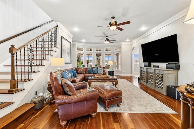 living room featuring ceiling fan, dark wood-type flooring, and ornamental molding