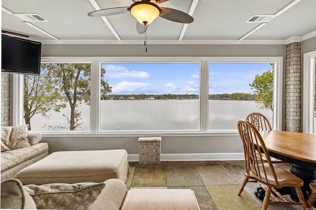 sunroom / solarium featuring ceiling fan