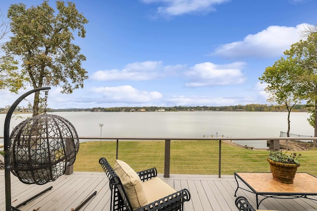 wooden terrace featuring a yard and a water view