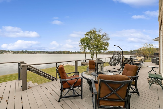 wooden terrace featuring a water view