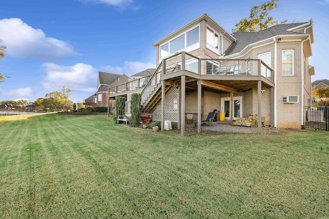 back of property featuring a yard, a wall mounted air conditioner, and a deck